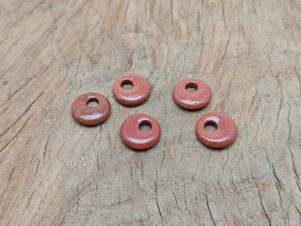 Goldstone crystal donut pendant, 18mm Pi stone from GemstoneGO, featuring a polished, shimmering goldstone gemstone with a smooth, round shape.