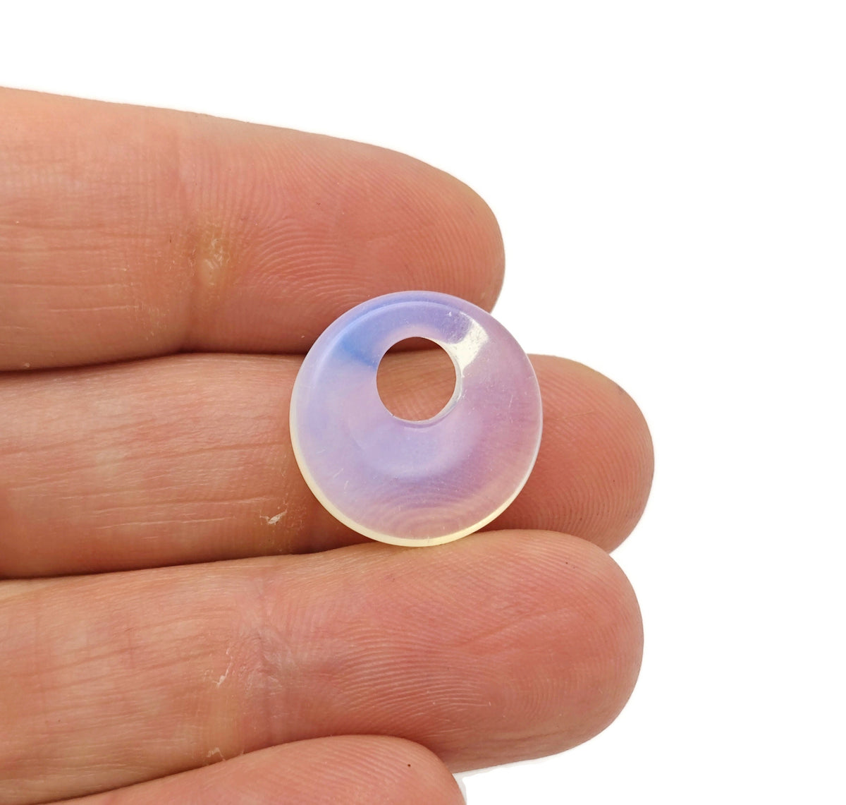 Opalite crystal donut pendant from GemstoneGO, 18mm Pi stone with smooth, polished surface and vibrant, glowing appearance.