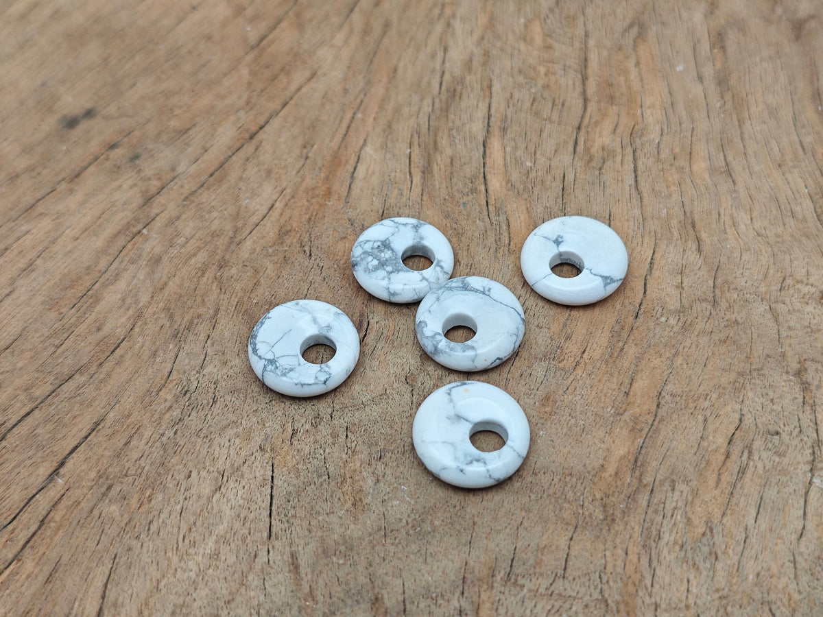 Howlite crystal donut pendant from GemstoneGO, 18mm Pi Stone with white and gray marbled appearance.