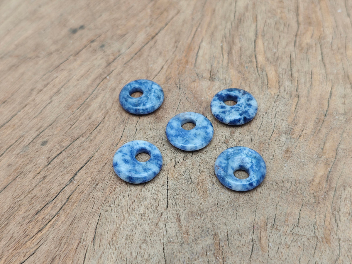 Sodalite crystal donut pendant, 18mm Pi Stone from GemstoneGO, showcasing deep blue and white natural mineral patterns.