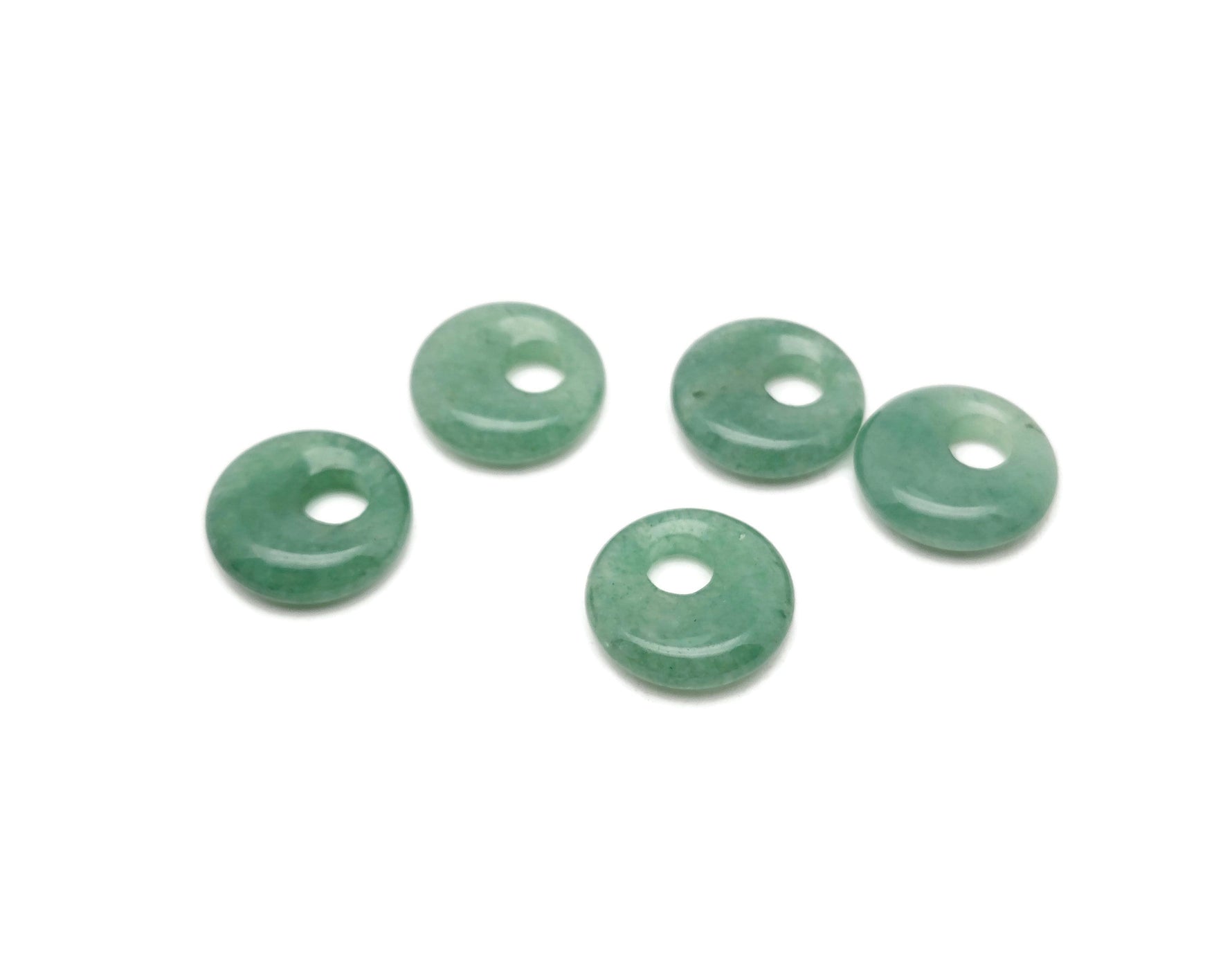 Aventurine crystal donut pendant from GemstoneGO, 18mm Pi stone with green, shimmering aventurine gemstone showing polished surface.