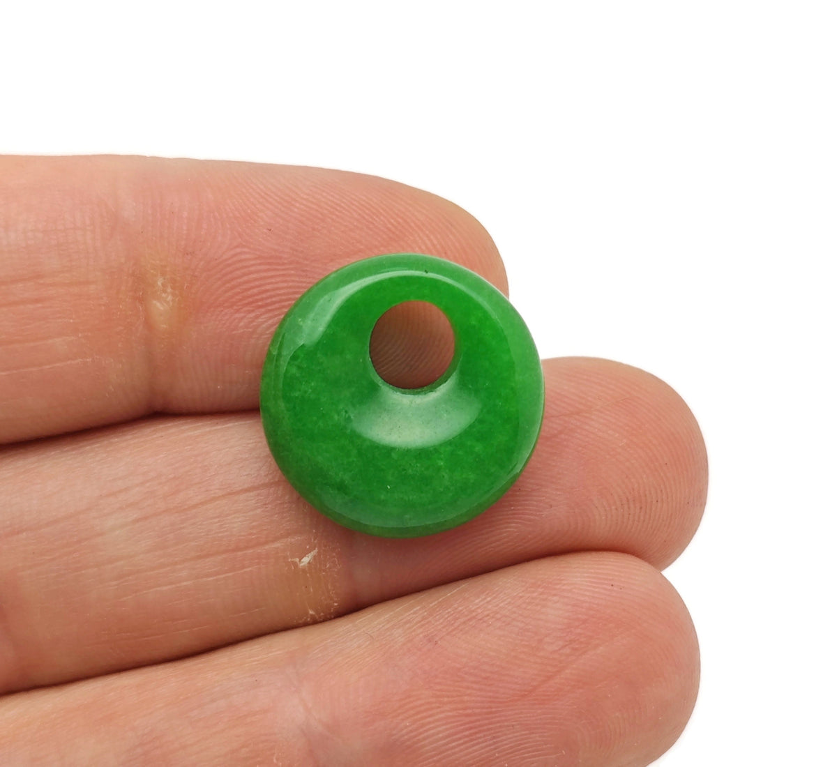 Green jade crystal donut pendant from GemstoneGO, 18mm Pi stone with smooth, polished surface and circular shape.