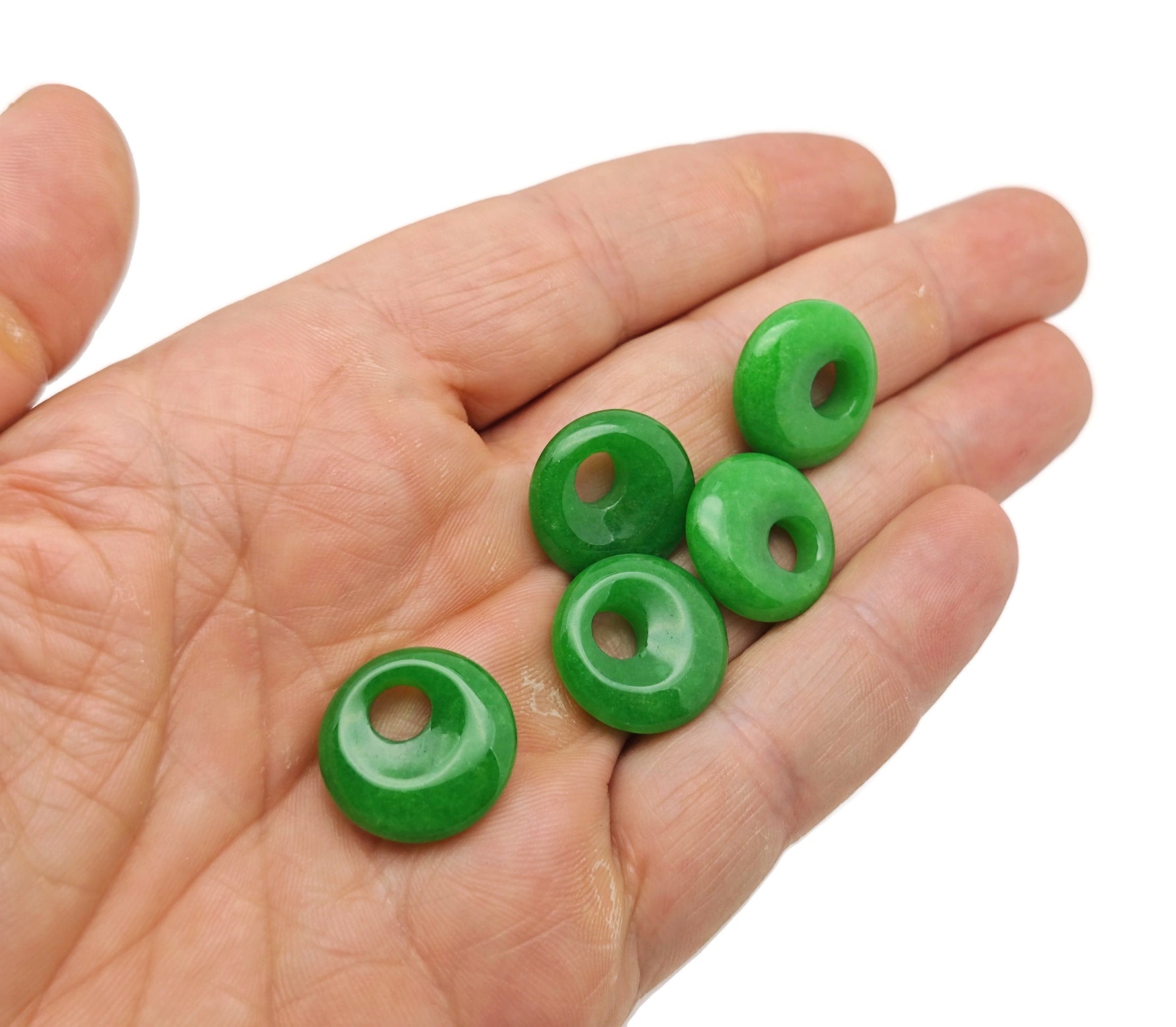 Green Jade crystal donut pendant from GemstoneGO, 18mm Pi Stone with a smooth, polished green jade surface and intricate details.