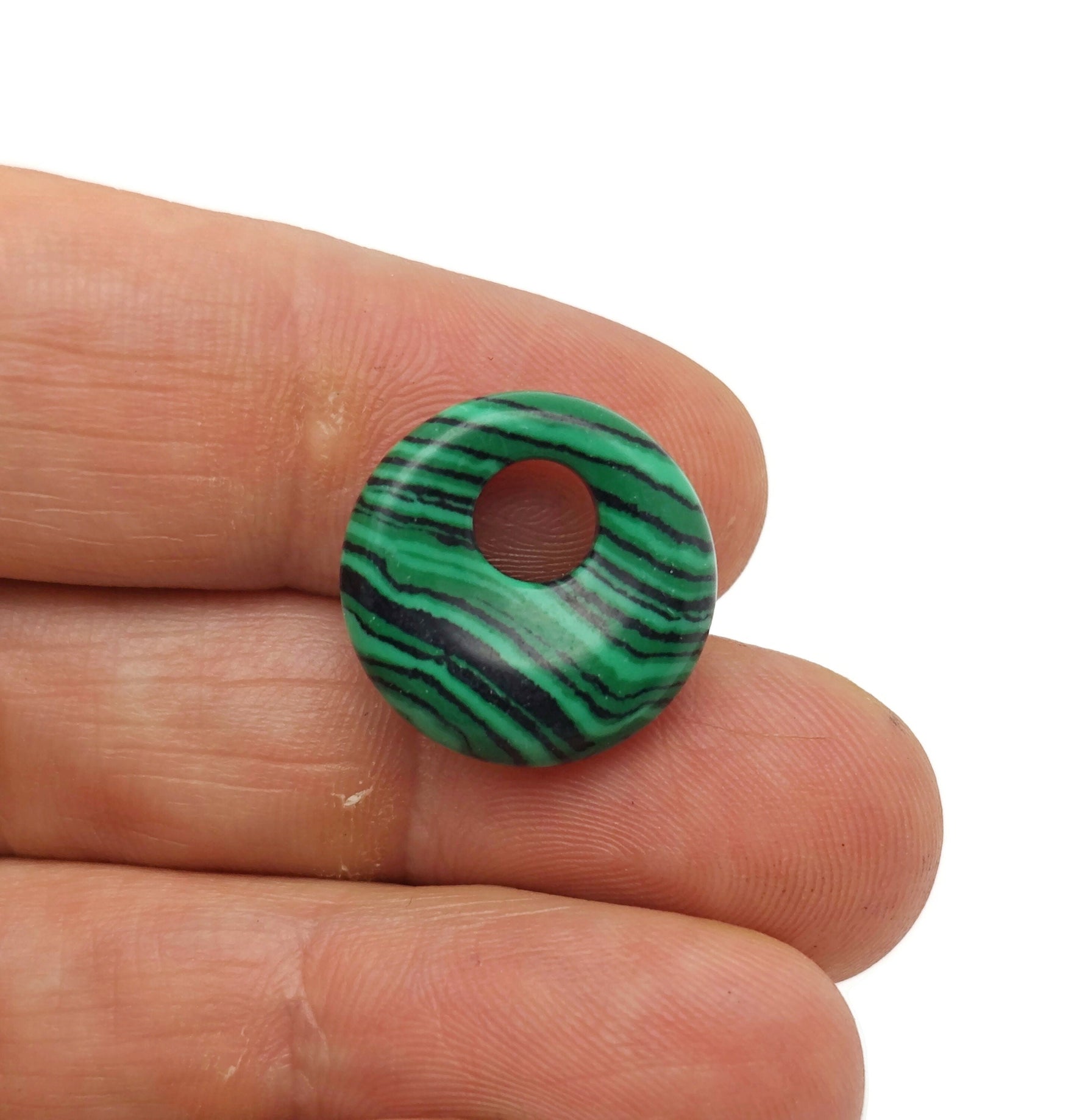 Malachite synthetic crystal donut pendant, 18mm Pi stone from GemstoneGO, with vibrant green and black banding, polished and smooth.