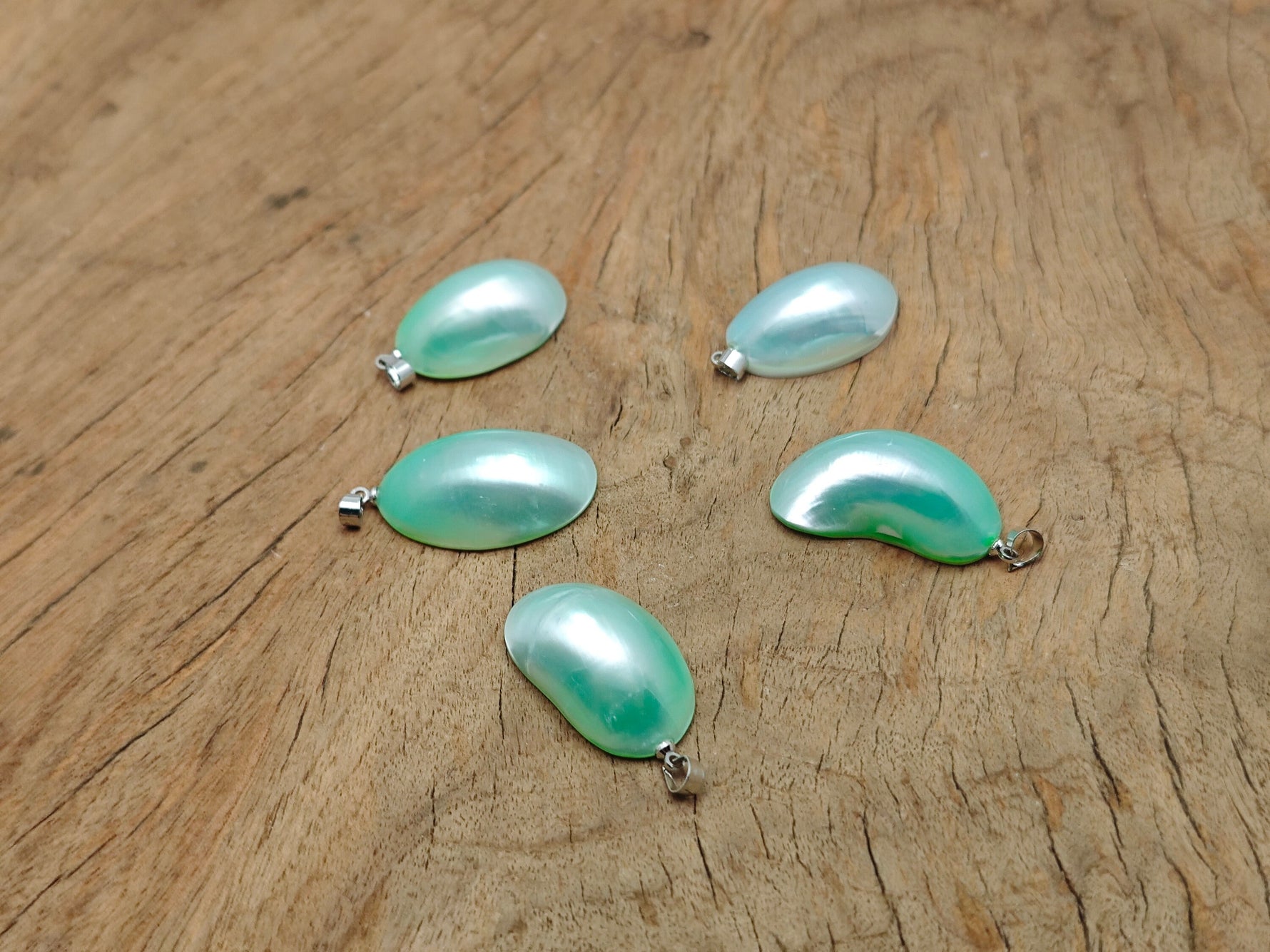 Green natural pearl pendant from GemstoneGO, showcasing a handcrafted jewelry piece with a smooth, lustrous pearl and crystal accents.