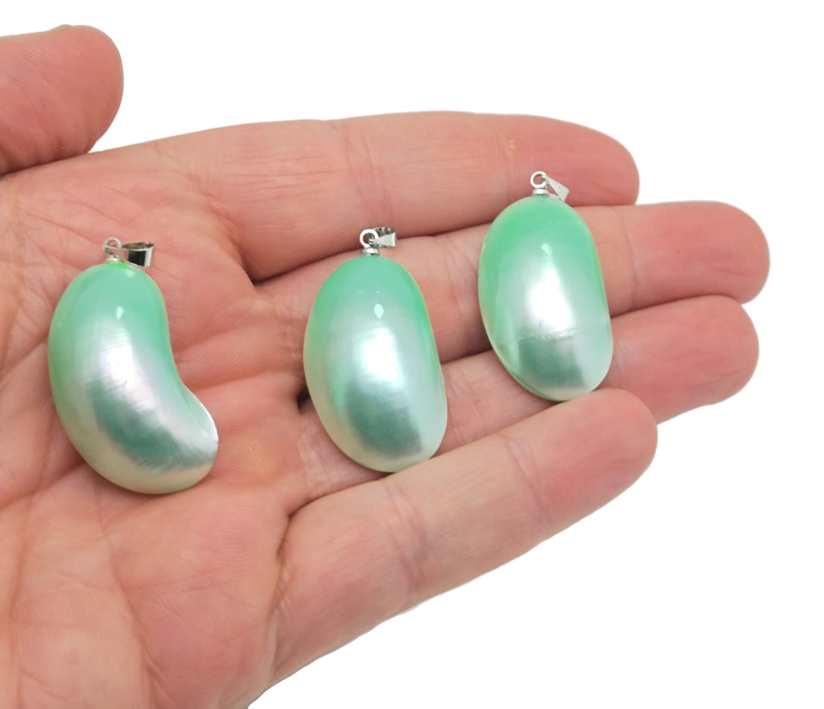 Green natural pearl pendant from GemstoneGO, showcasing a lustrous pearl with a silver setting, ideal for jewelry making.