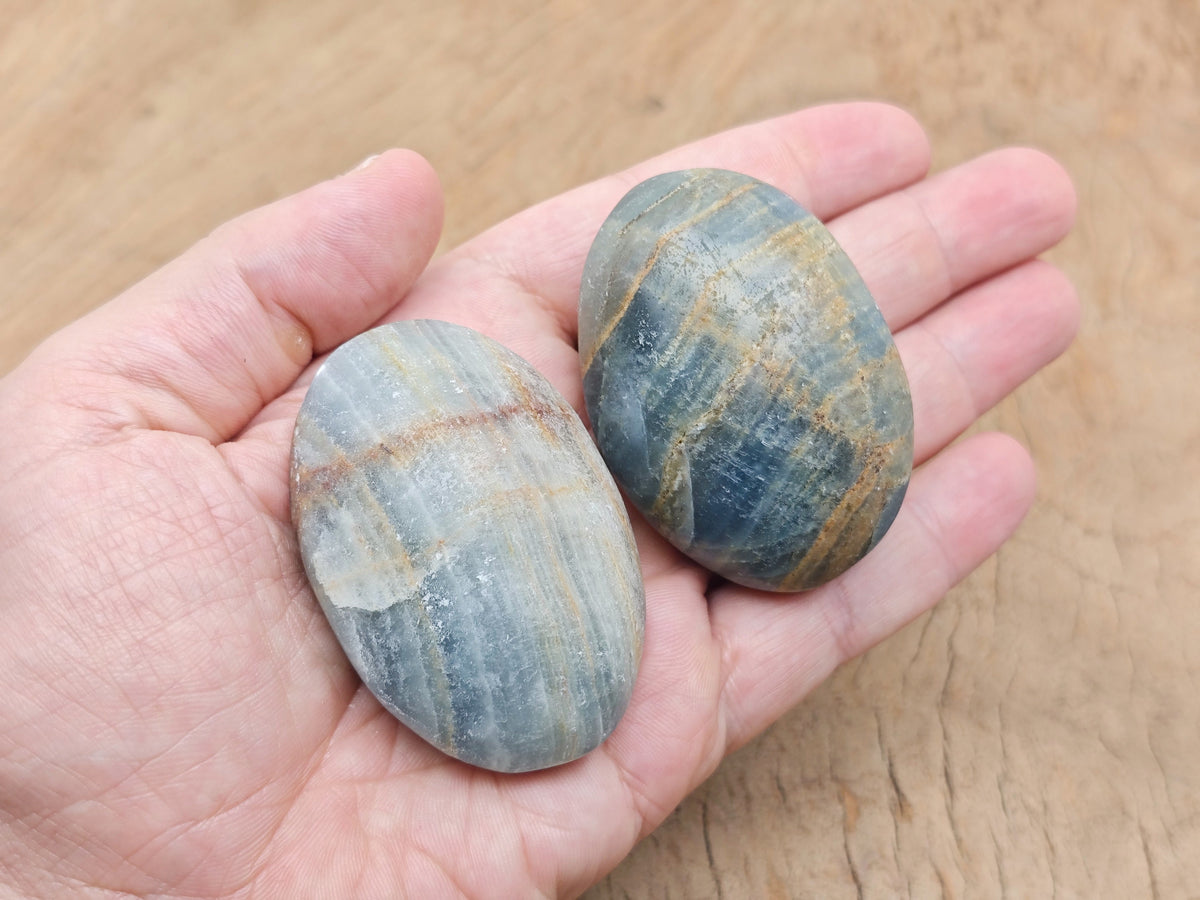 Blue onyx palm gemstone spa stone from GemstoneGO, smooth polished stone ideal for relaxation and massage therapy.