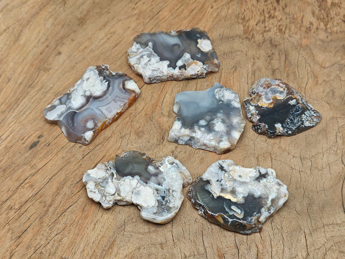 Flower Agate flat gemstone slab featuring cherry blossom patterns, showcasing vibrant pink and white crystal details.