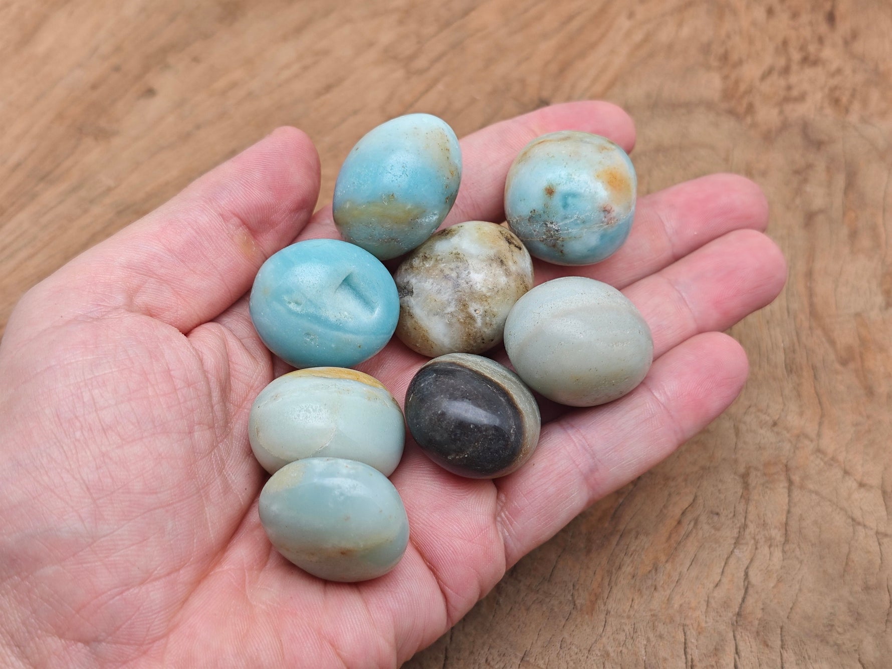 Caribbean Calcite tumbled stone from GemstoneGO, smooth orange and yellow mineral with vibrant natural patterns.
