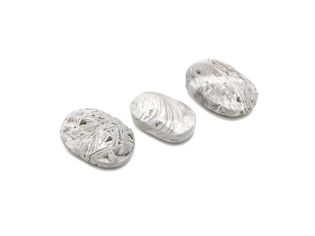 Mexican White Agate palm gemstone spa stone from GemstoneGO, showcasing smooth, polished white agate with natural banding patterns.