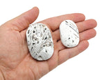 Mexican White Agate palm gemstone spa stone from GemstoneGO, smooth round stone ideal for relaxation and healing.