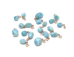 Larimar crystal pendant with gold setting from GemstoneGO, showcasing a vibrant blue and white marbled gemstone design.