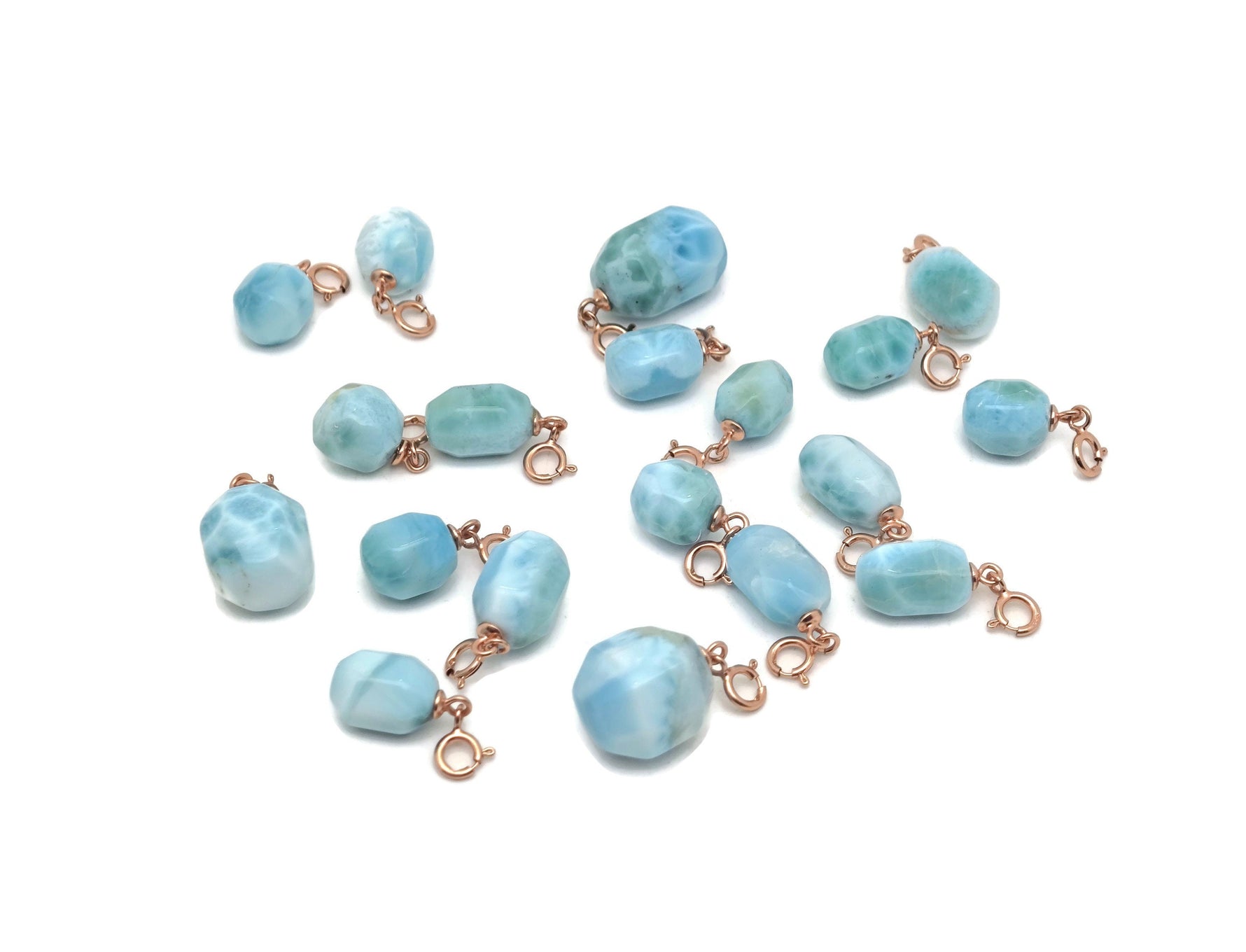 Larimar crystal pendant with gold setting from GemstoneGO, showcasing a vibrant blue and white marbled gemstone design.