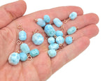 Larimar crystal pendant with gold setting, showcasing a vibrant blue gemstone in a elegant jewelry design.