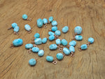 Larimar crystal pendant with gold setting from GemstoneGO, showcasing a smooth, oval-shaped blue gemstone on a delicate chain.