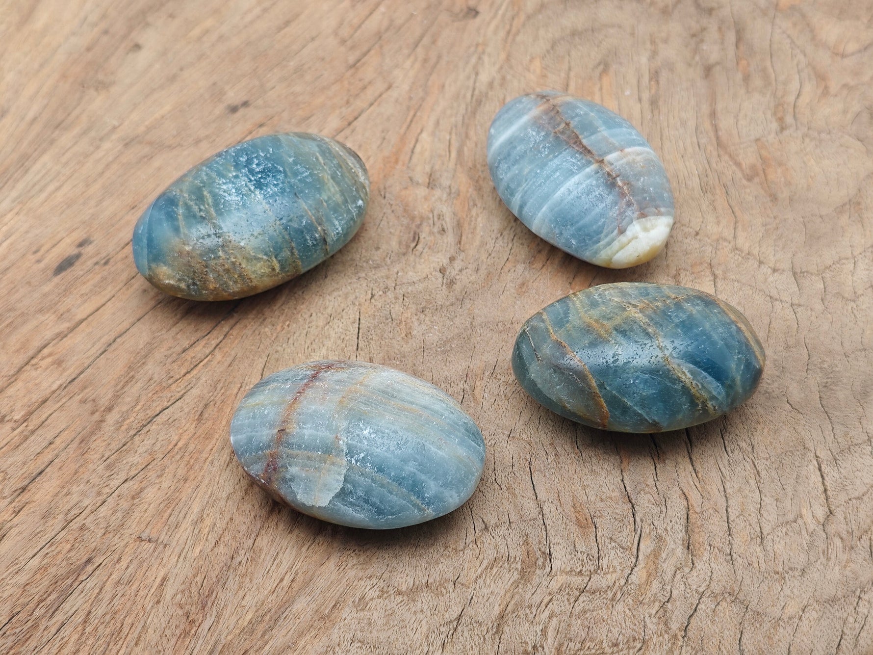 Blue Onyx palm gemstone spa stone from GemstoneGO, showing smooth, polished blue onyx with natural gemstone veins and rounded shape.
