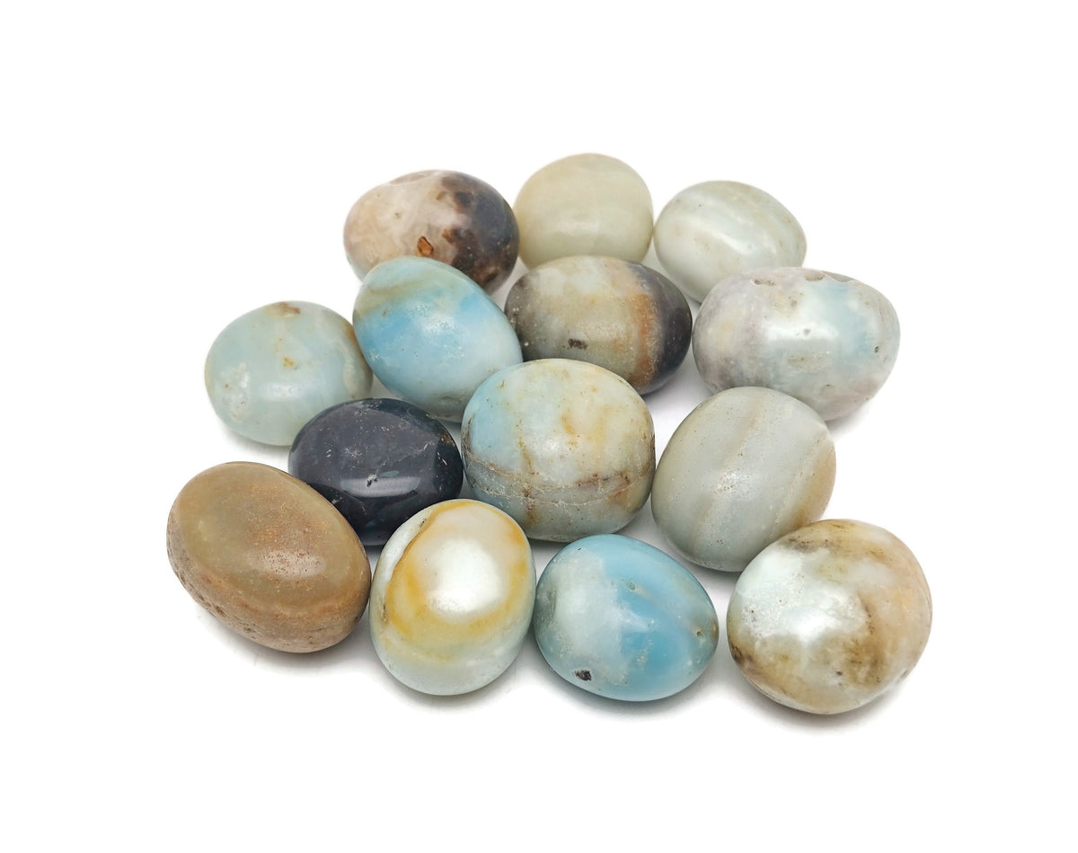 Caribbean calcite tumbled stone from GemstoneGO showing smooth, rounded orange and green mineral with a polished surface.