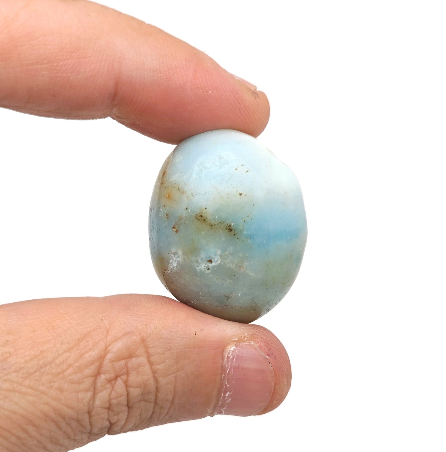 Caribbean Calcite tumbled stone by GemstoneGO showing smooth, polished blue and white mineral surface.