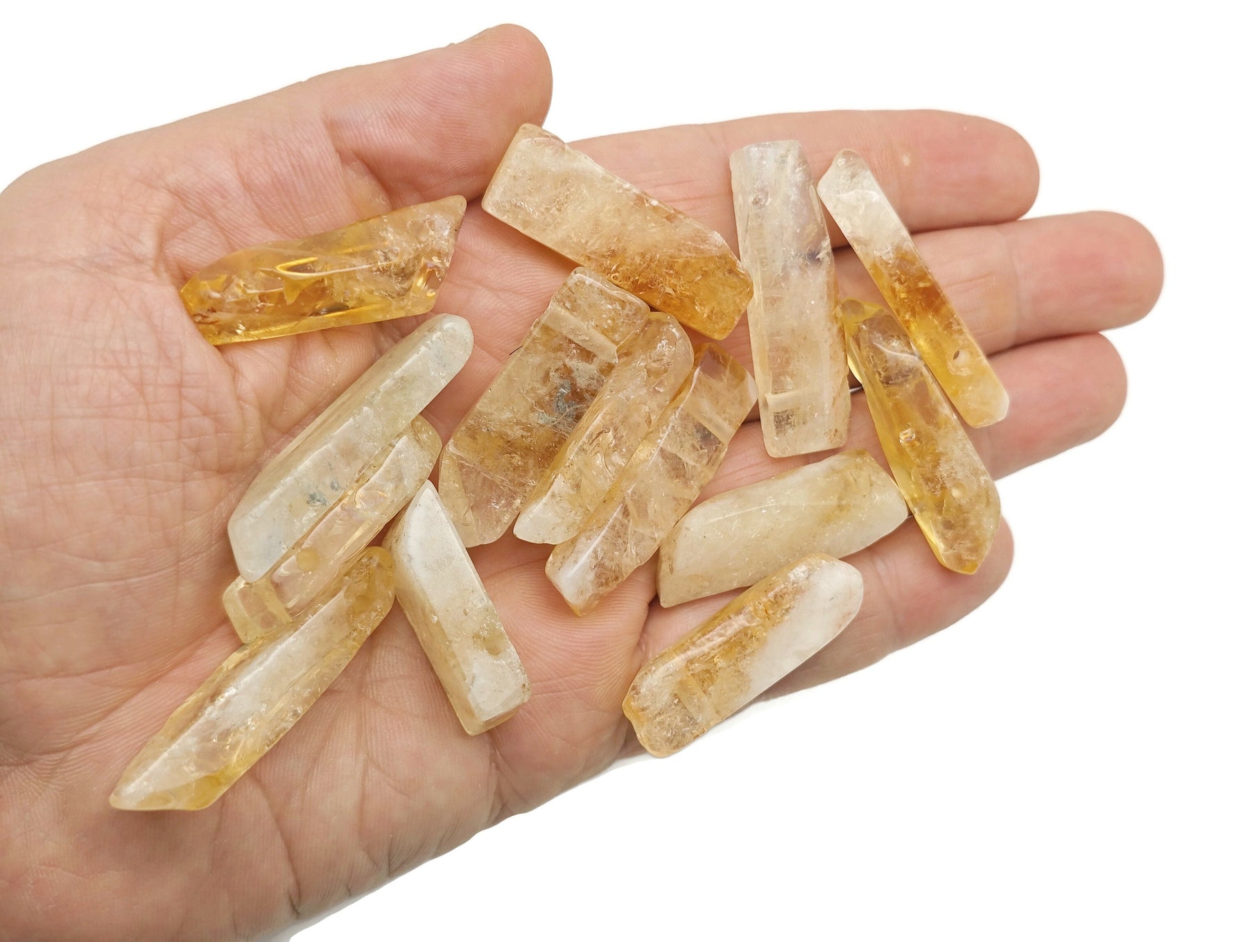 Citrine drilled tumbled gemstone pendant from GemstoneGO showcasing a vibrant orange-yellow polished stone with a drilled hole for jewelry.