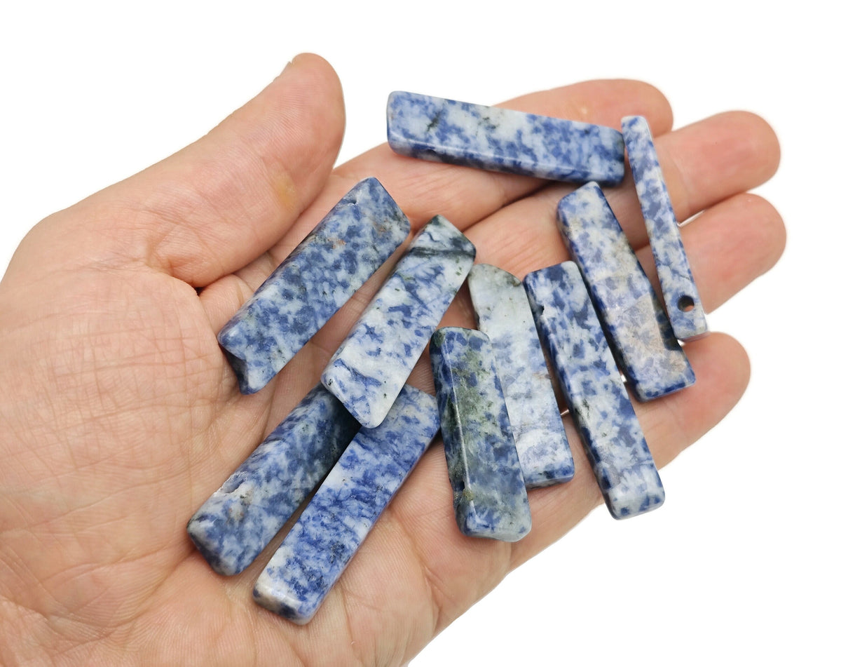 Blue Spot Jasper gemstone pendant from GemstoneGO featuring a drilled tumbled stone with natural blue and brown spot patterns.