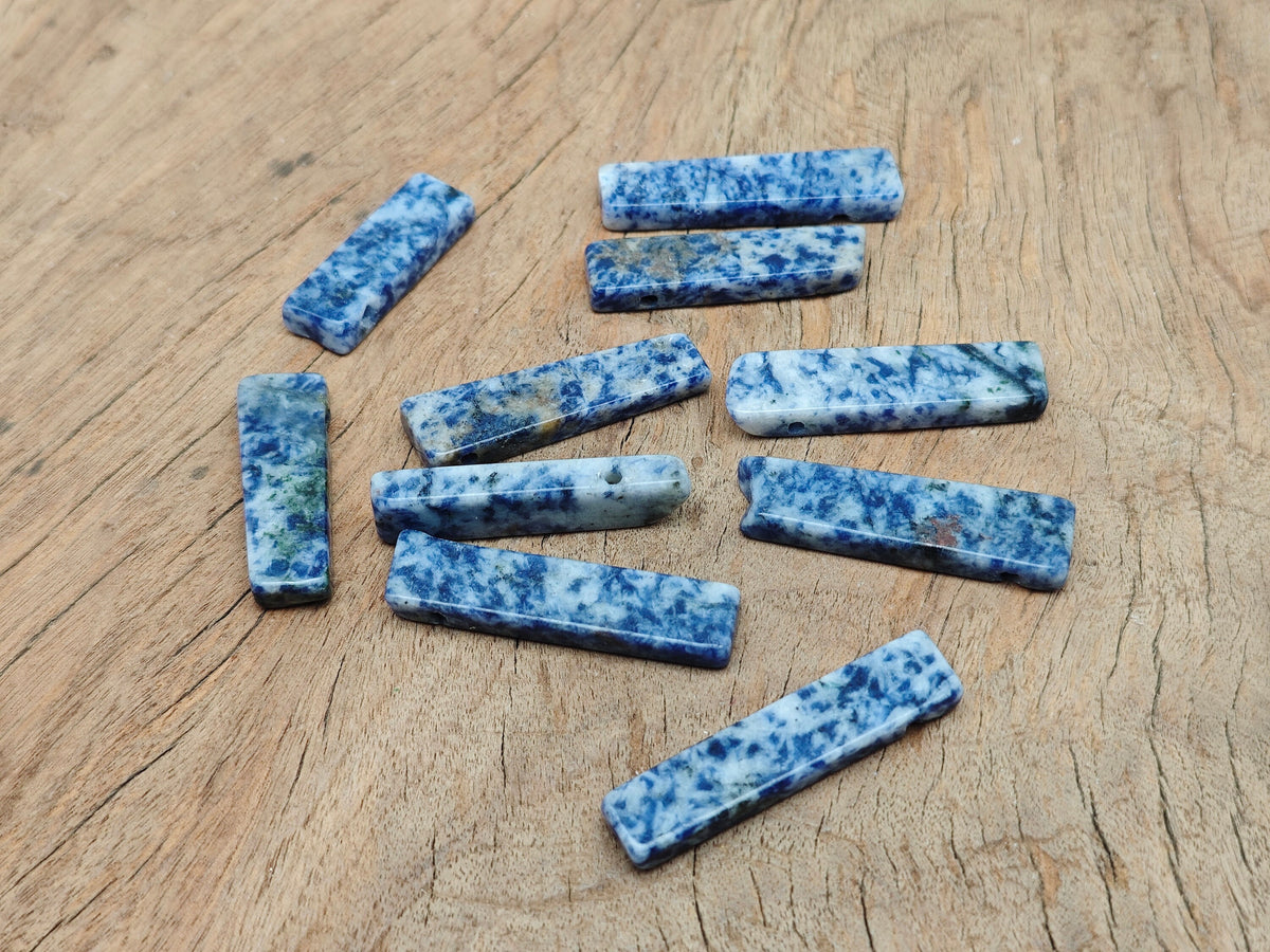 Blue Spot Jasper gemstone pendant drilled and tumbled, showcasing vibrant blue spots on a smooth polished surface.