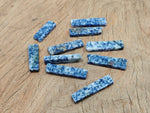Blue Spot Jasper gemstone pendant drilled and tumbled, showcasing vibrant blue spots on a smooth polished surface.