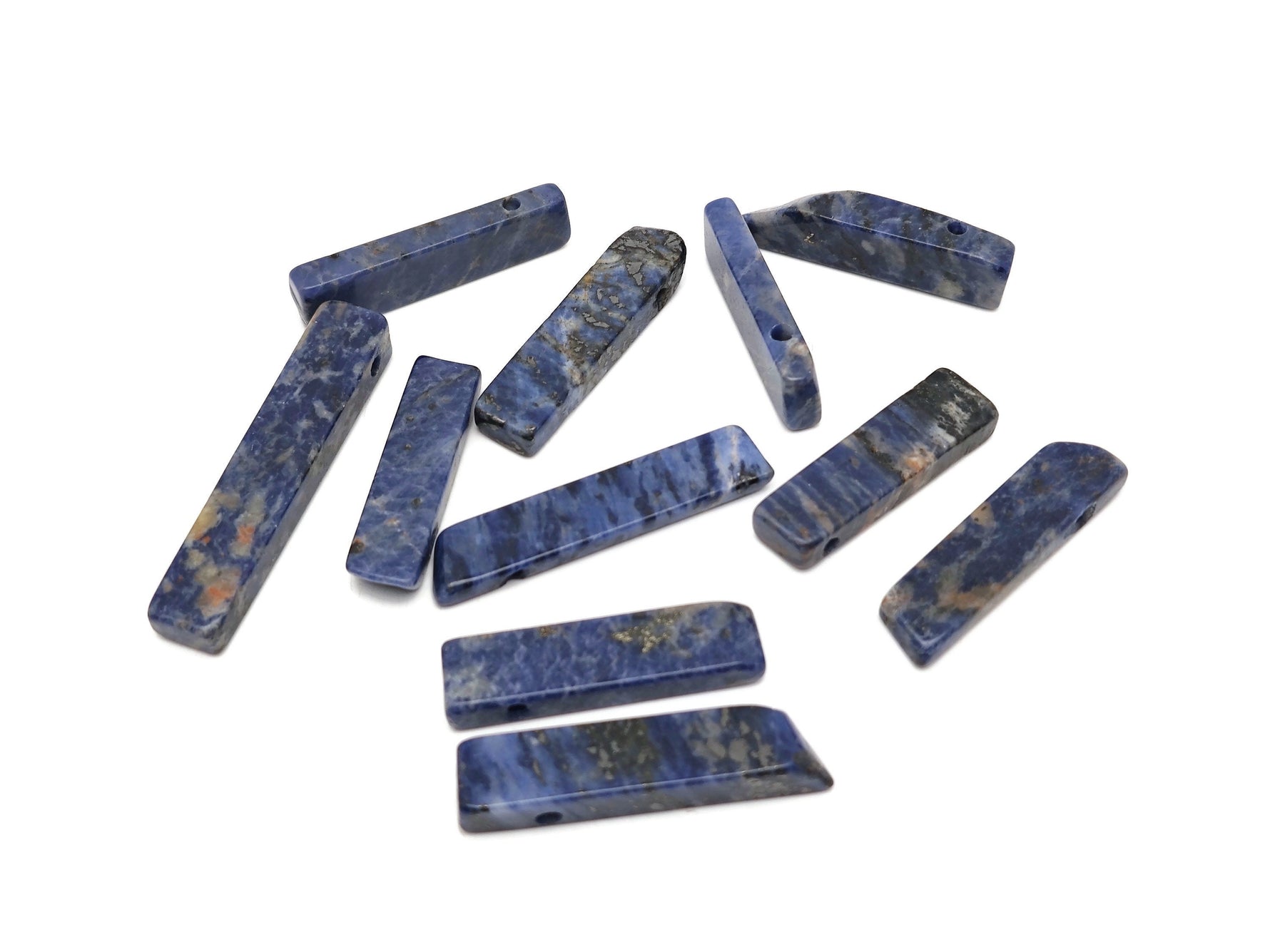 Sodalite drilled tumbled gemstone pendant from GemstoneGO showcasing a deep blue, polished stone with natural veining and a drilled hole for jewelry.