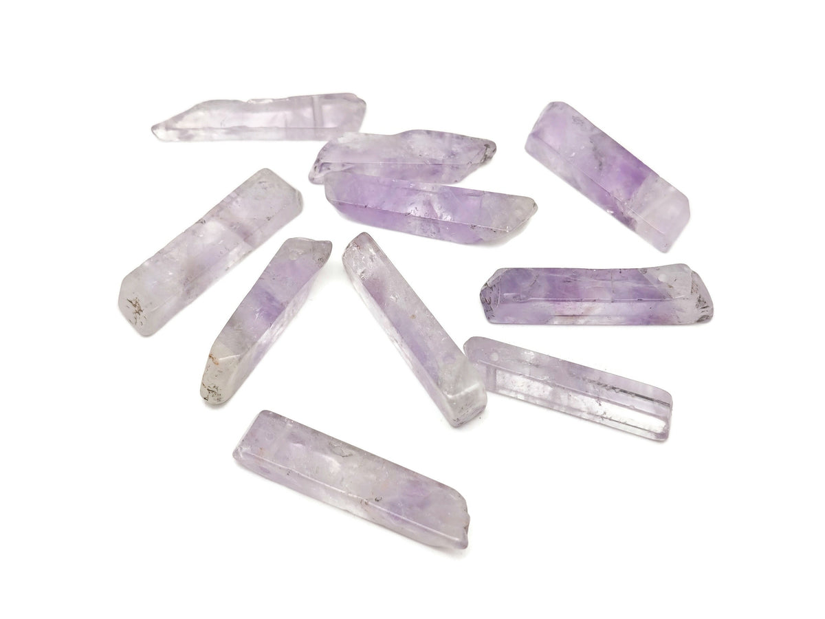 Amethyst drilled tumbled gemstone pendant from GemstoneGO showing a polished purple amethyst stone with drilled hole for jewelry.