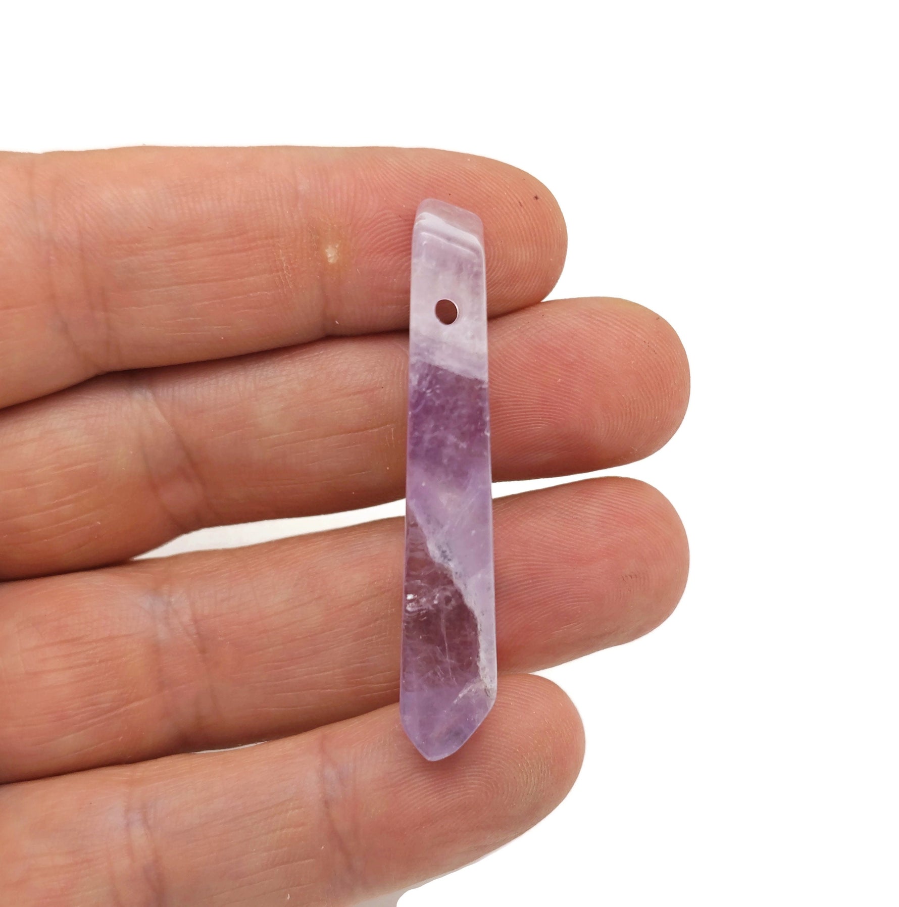 Amethyst drilled tumbled gemstone pendant from GemstoneGO, showcasing a smooth purple amethyst stone with drilled hole for jewelry.