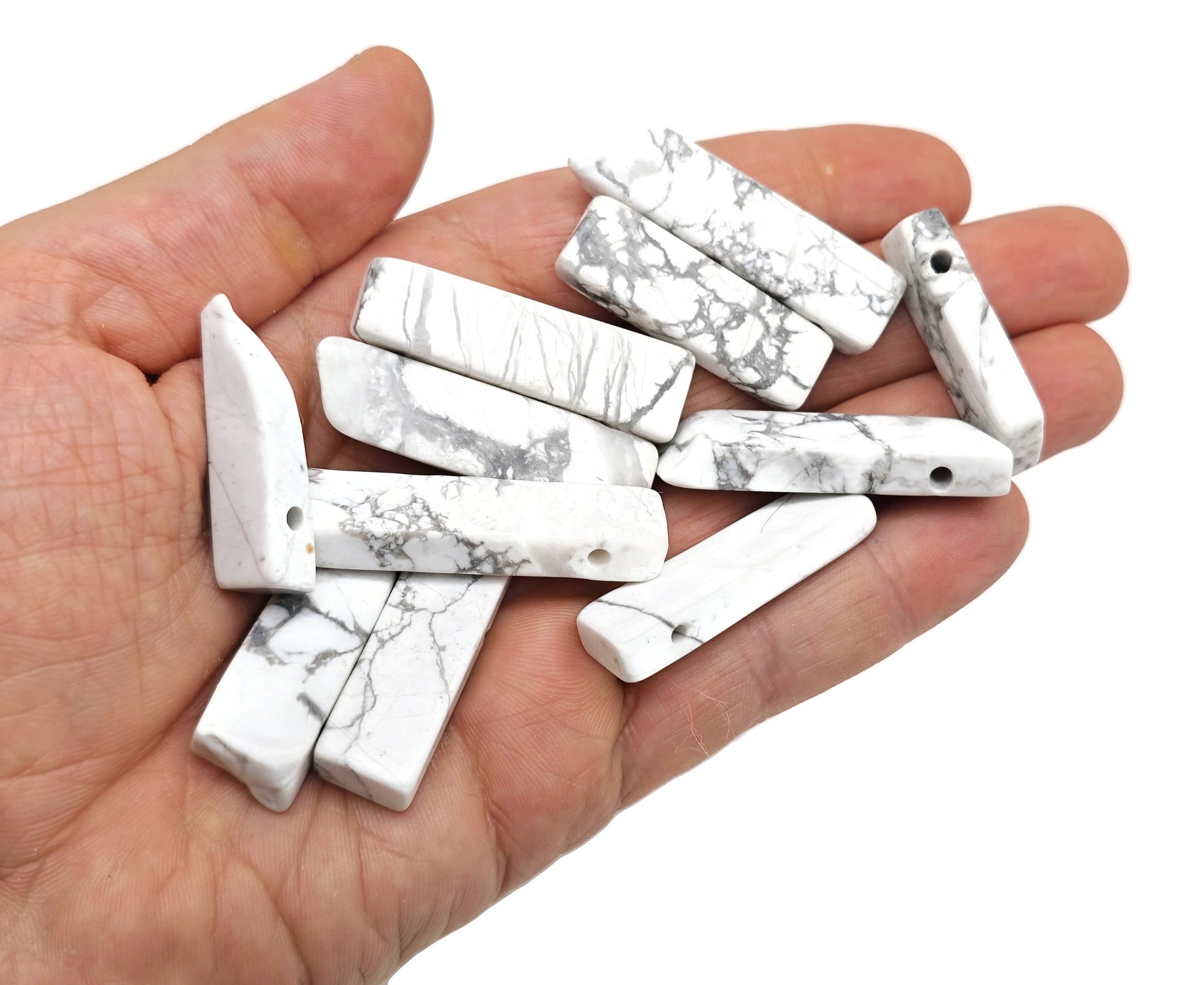 Howlite drilled tumbled gemstone pendant from GemstoneGO, showcasing a smooth, polished white stone with natural gray veining.