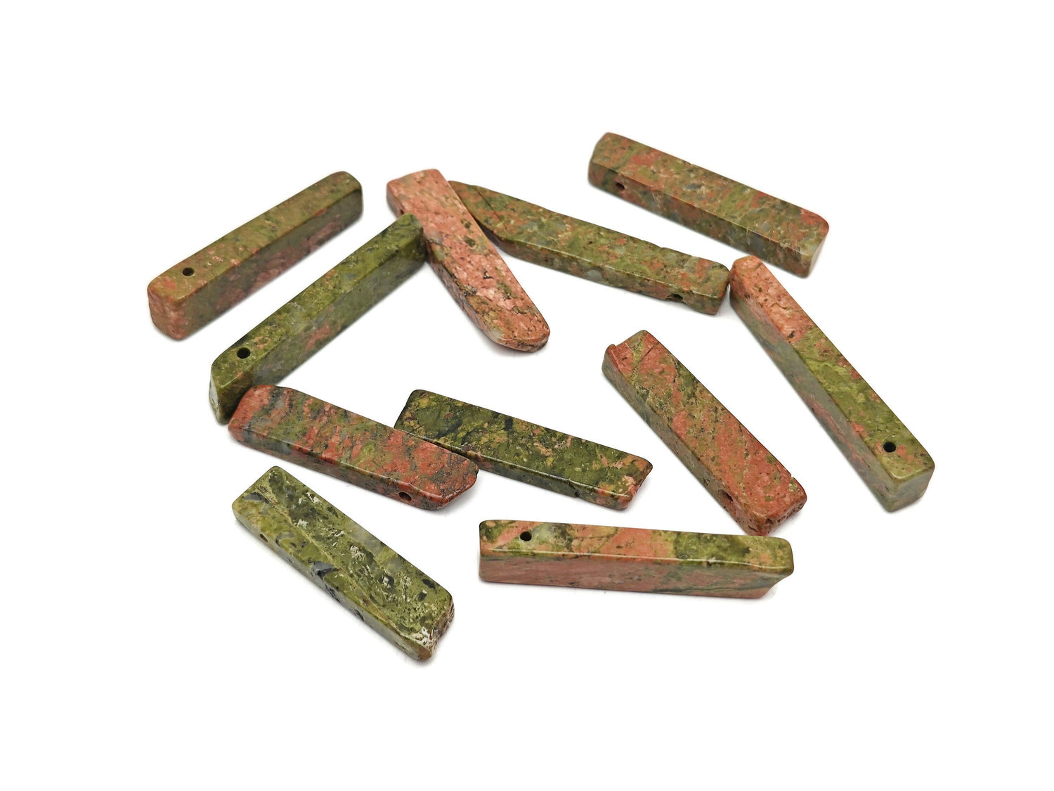 Unakite drilled tumbled gemstone pendant from GemstoneGO showcasing a smooth, polished green and pink stone with drilled hole for jewelry.