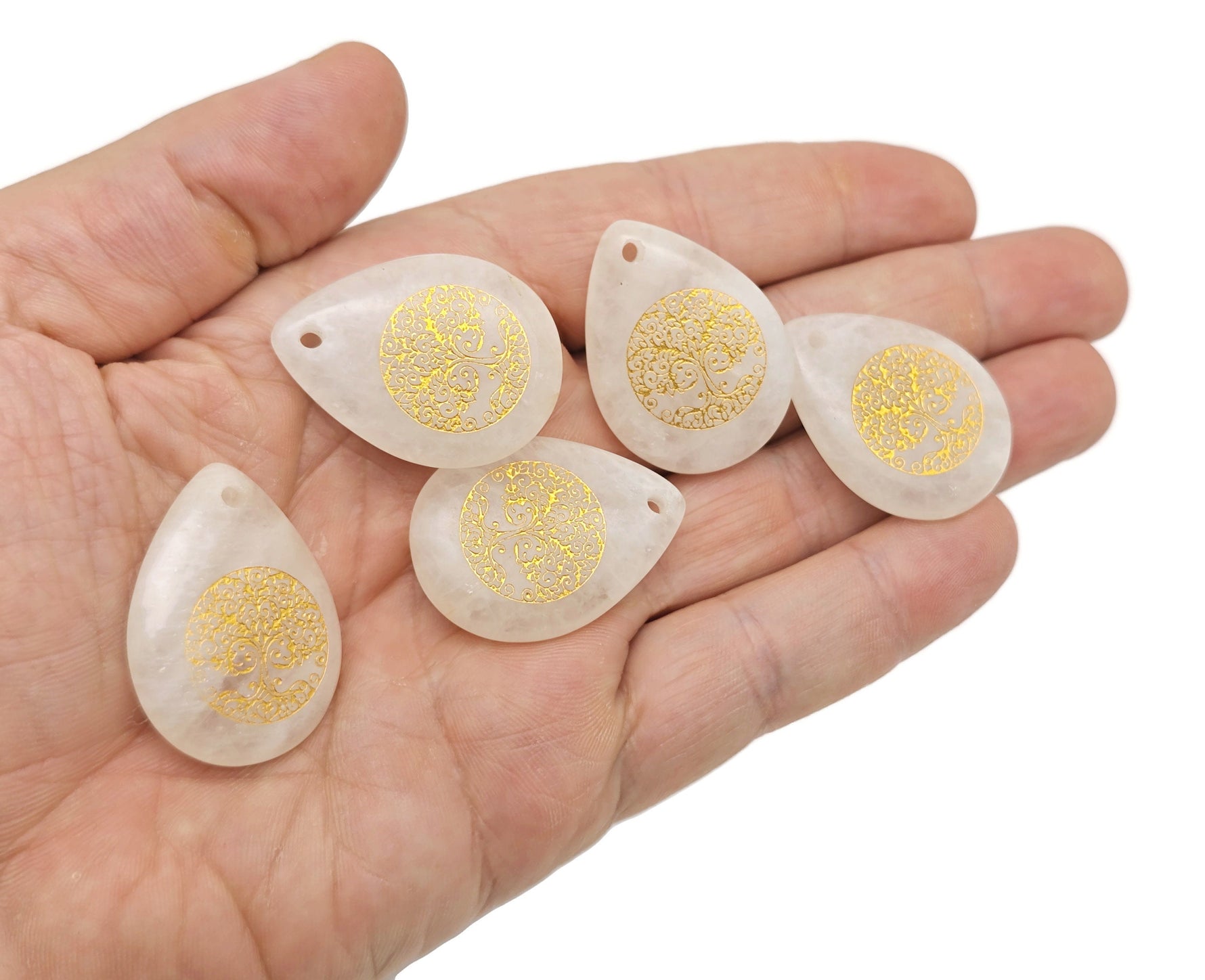 Drilled teardrop crystal pendant with Tree of Life engraving by GemstoneGO, showcasing intricate gemstone craftsmanship.
