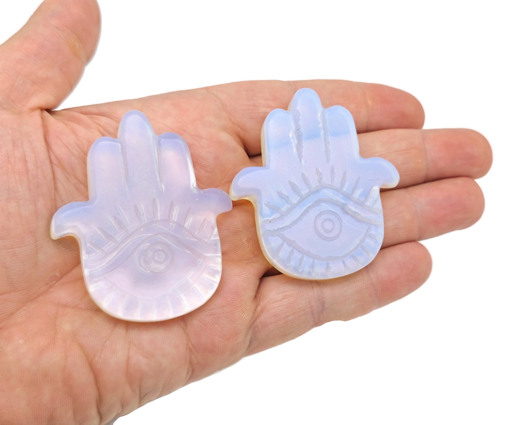 Evil Eye hand gemstone carving pocket crystal with chakra and meditation crystal design, showcasing vibrant colors and intricate details.