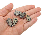Dalmatian Jasper gemstone pendant featuring a pine tree design, mini crystal pendant with black spots on a silver chain.