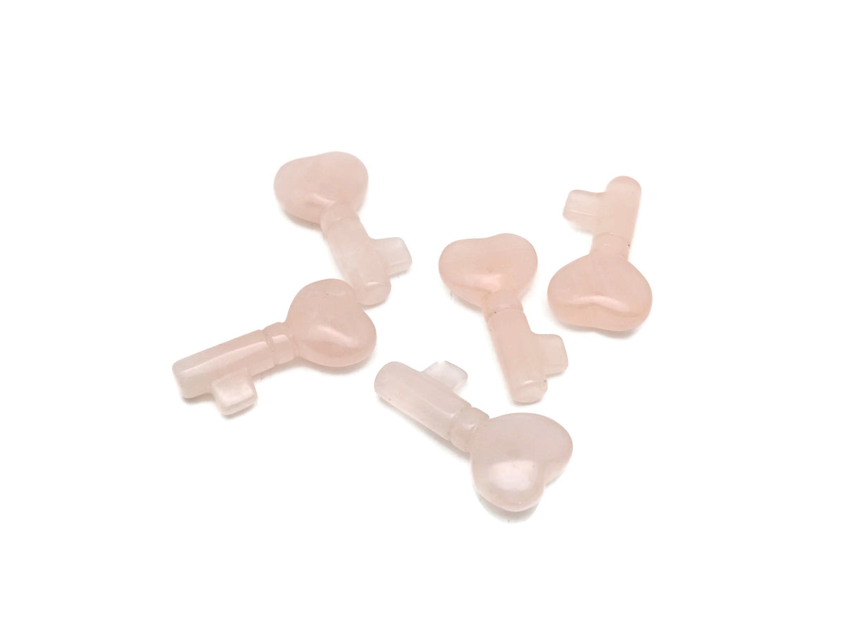 Rose quartz key gemstone carving, 40mm, from GemstoneGO, detailed pink stone with smooth polished surface and intricate carvings.