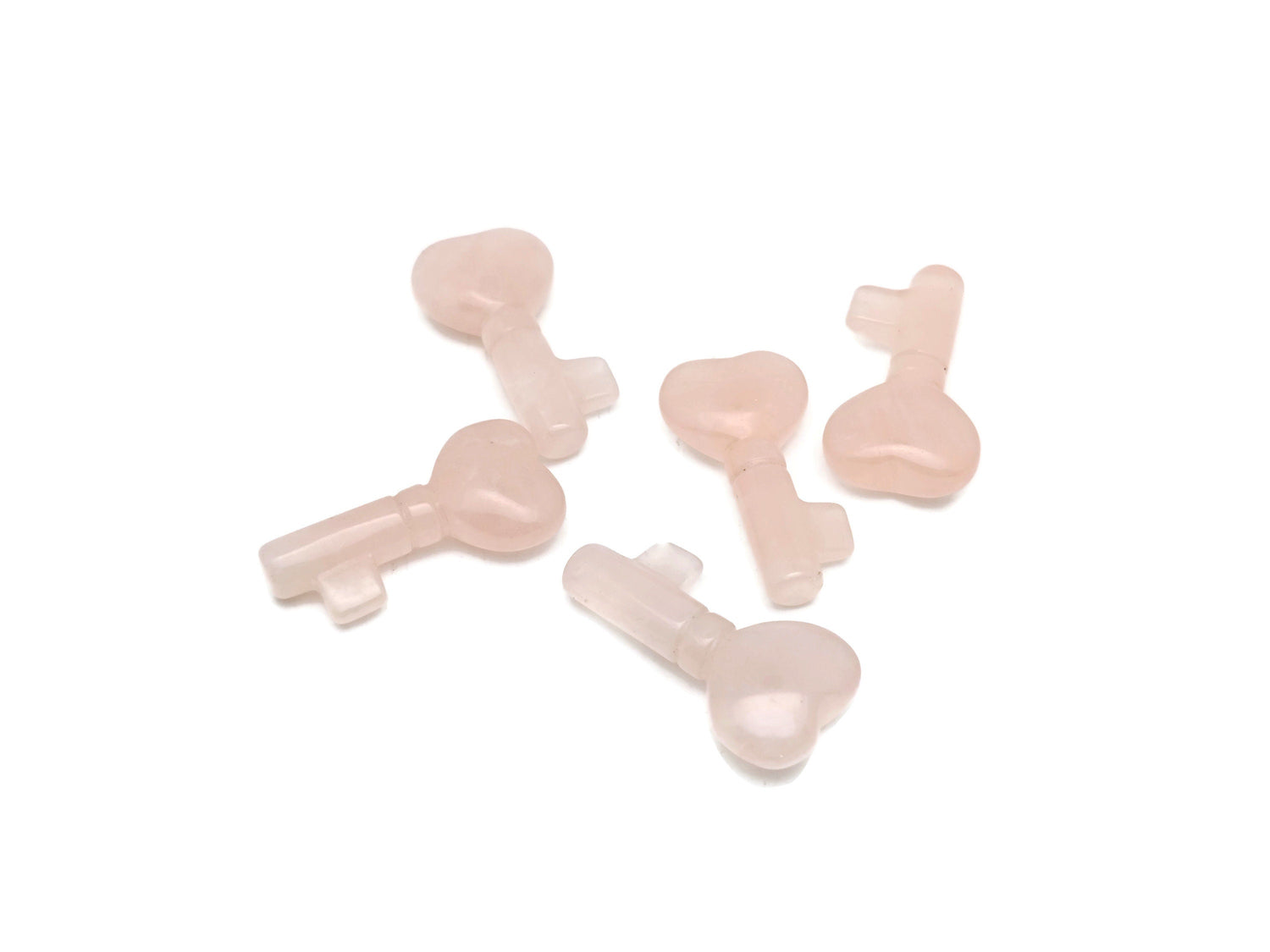Rose quartz key gemstone carving, 40mm, from GemstoneGO, detailed pink stone with smooth polished surface and intricate carvings.