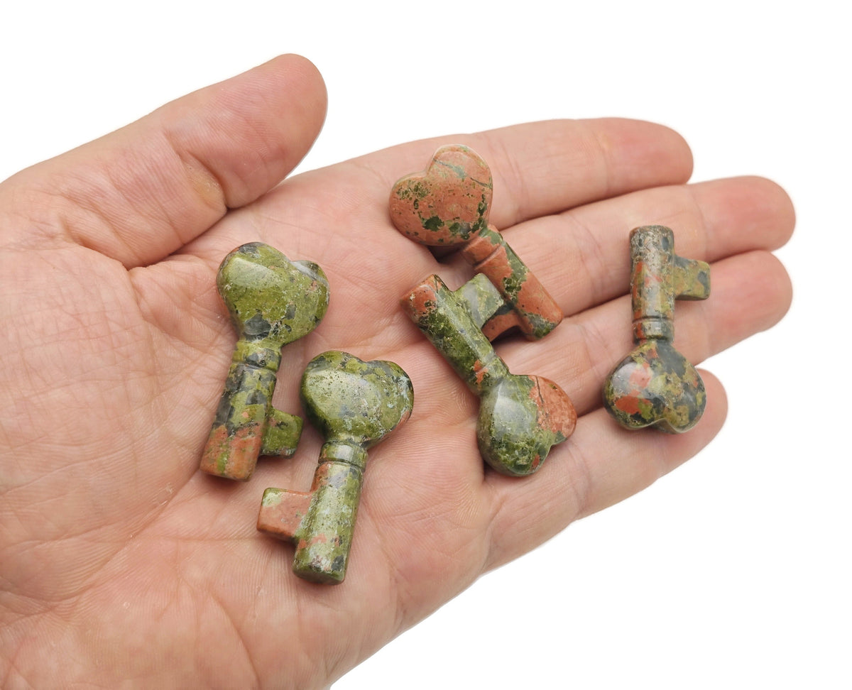Unakite key gemstone carving, 40mm, from GemstoneGO, showing detailed green and pink mineral patterns on a polished surface.