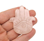 Rose quartz evil eye hand gemstone carving from GemstoneGO, featuring detailed craftsmanship and vibrant pink color.