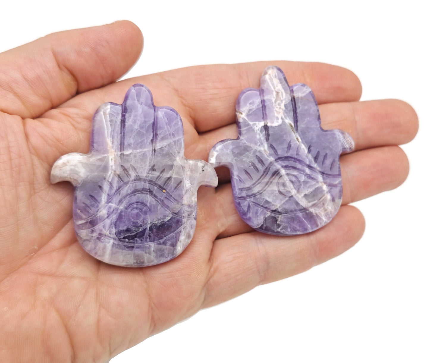 Amethyst evil eye hand gemstone carving by GemstoneGO, featuring detailed purple amethyst with protective evil eye design.