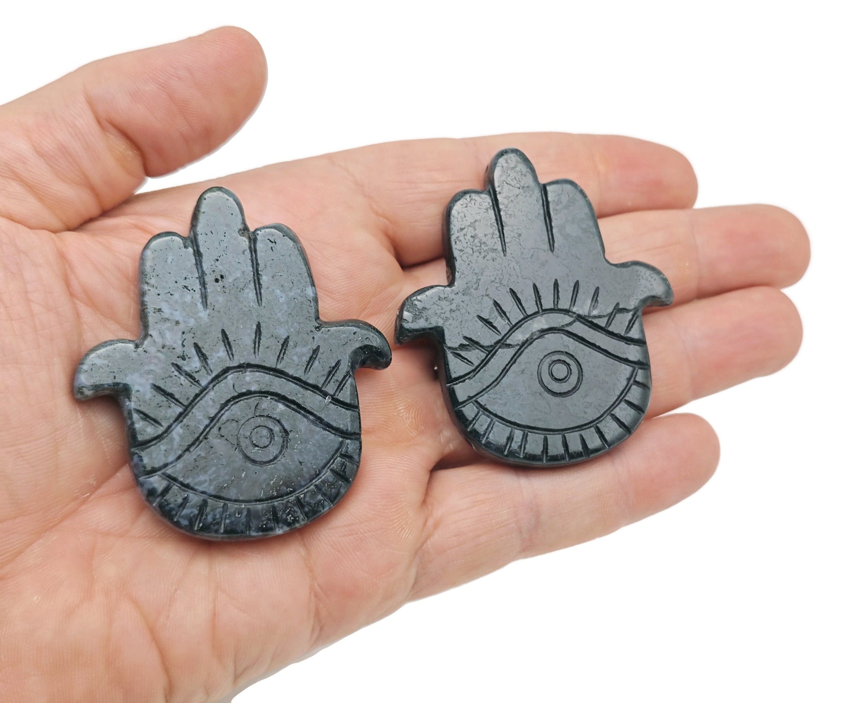 Moss agate evil eye hand gemstone carving with intricate details, crafted by GemstoneGO, showcasing natural stone patterns.