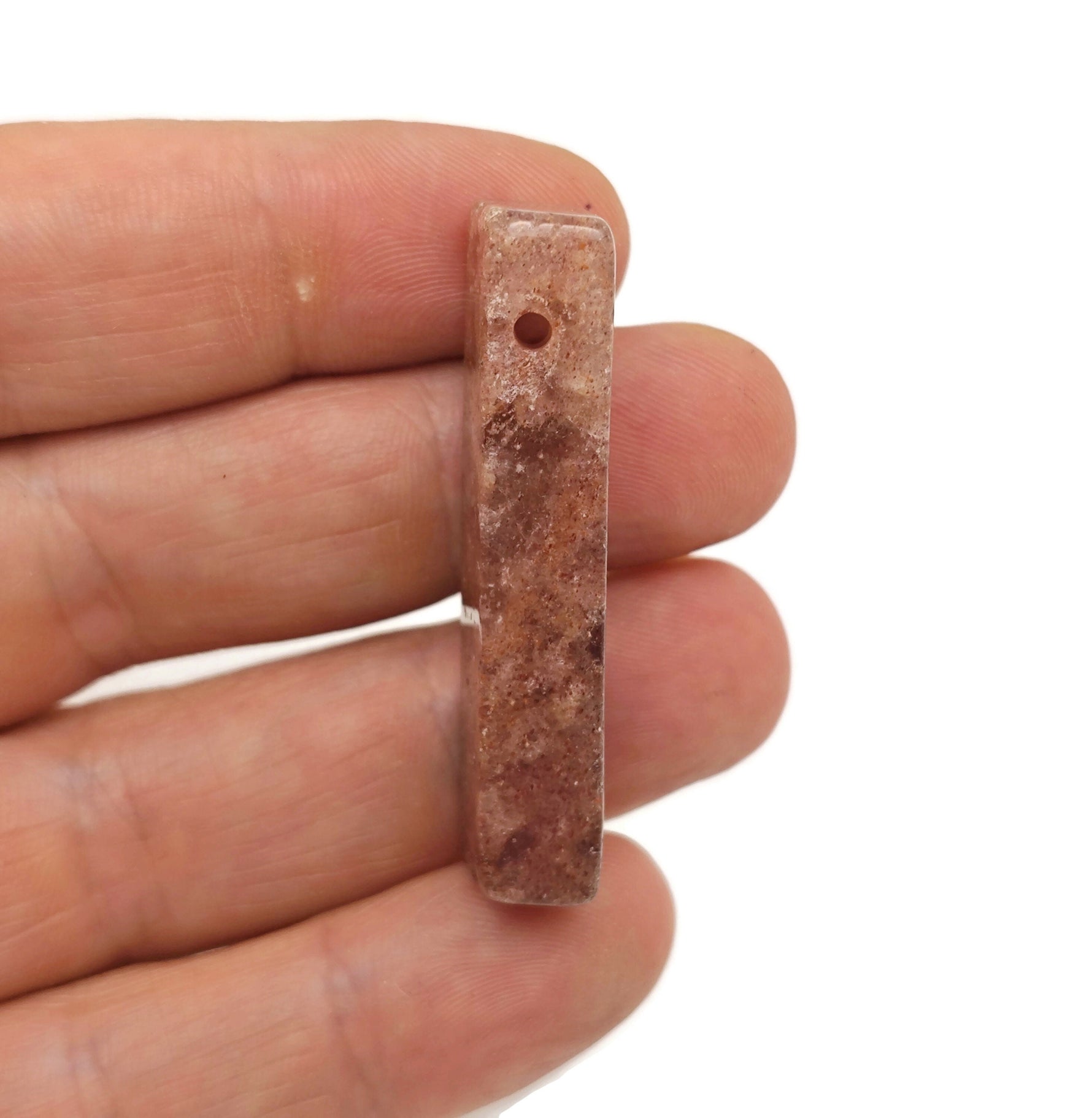 Strawberry Quartz drilled tumbled gemstone pendant from GemstoneGO, showcasing a polished pink stone with a drilled hole for jewelry.