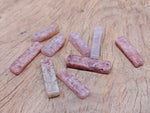 Strawberry Quartz drilled tumbled gemstone pendant from GemstoneGO, showcasing a smooth, polished pink stone with drilled hole for jewelry.