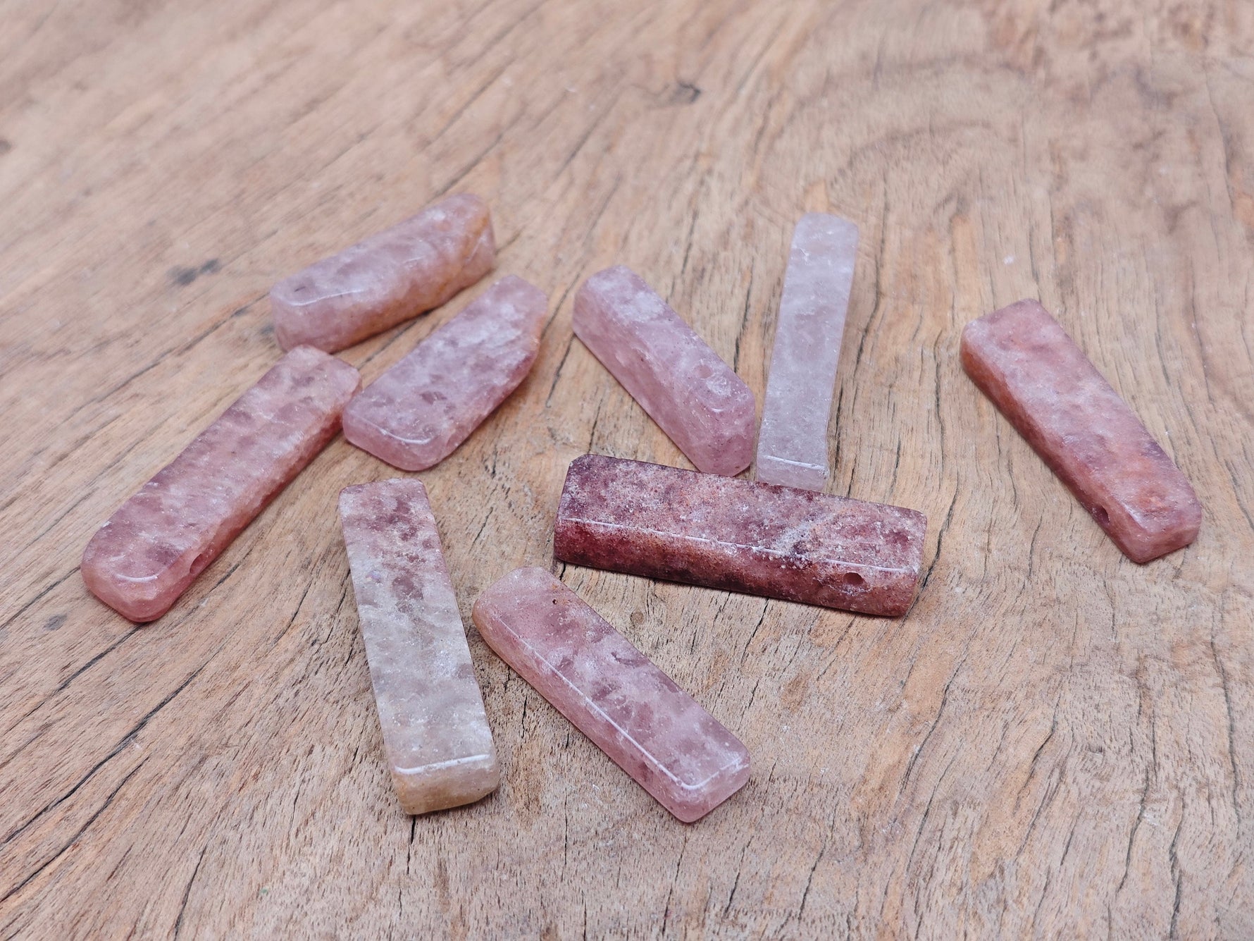 Strawberry Quartz drilled tumbled gemstone pendant from GemstoneGO, showcasing a smooth, polished pink stone with drilled hole for jewelry.