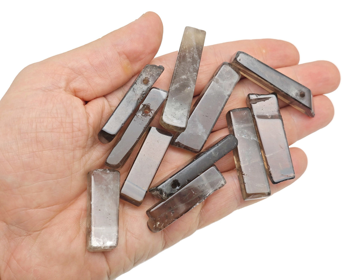 Smoky quartz drilled tumbled gemstone pendant from GemstoneGO, showcasing a smooth, polished dark brown mineral with a natural hole.