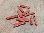 Red Jasper drilled tumbled gemstone pendant from GemstoneGO, showcasing a smooth, polished red jasper stone with a drilled hole for jewelry.