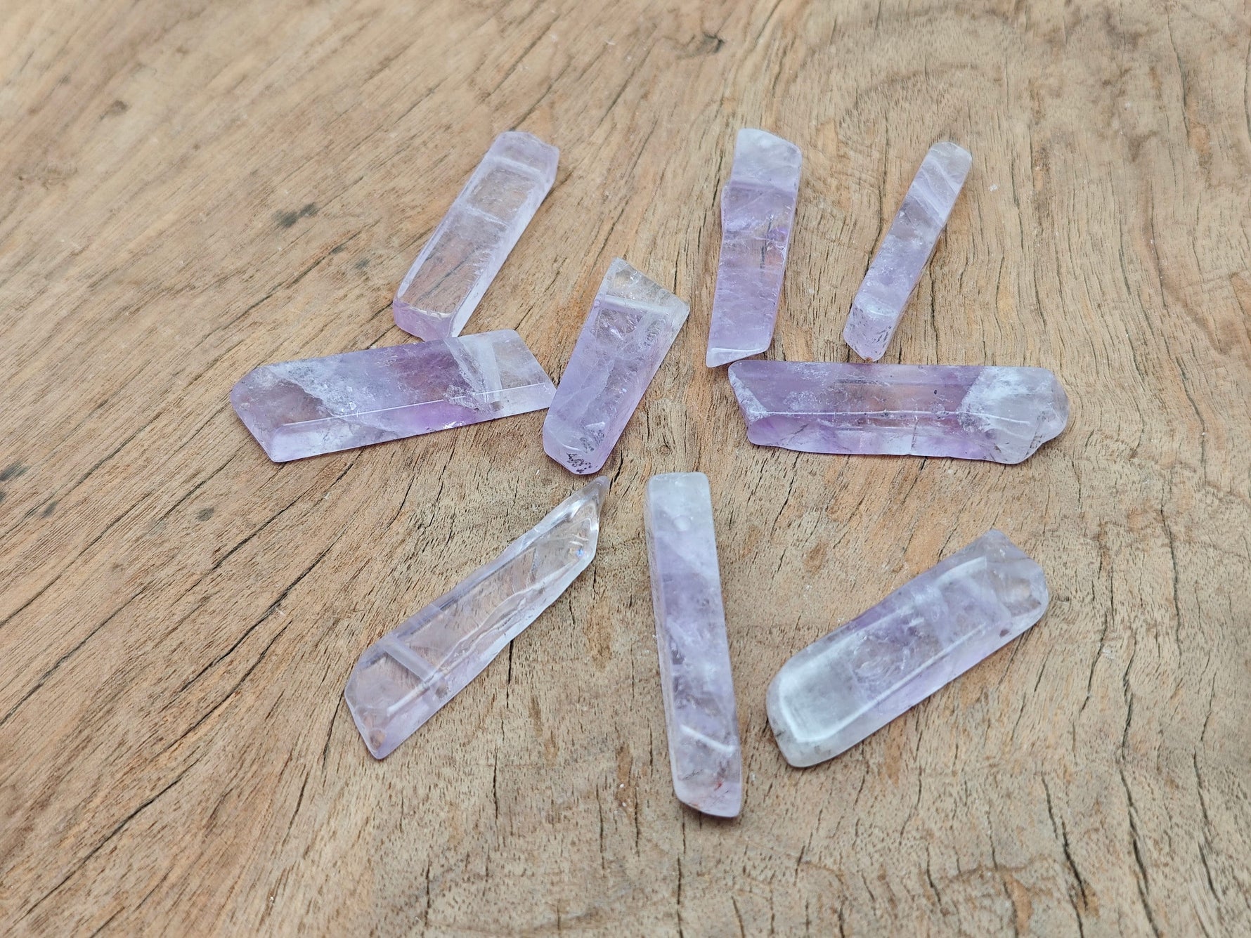 Amethyst drilled tumbled gemstone pendant from GemstoneGO showing a smooth purple amethyst stone with drilled hole for jewelry.