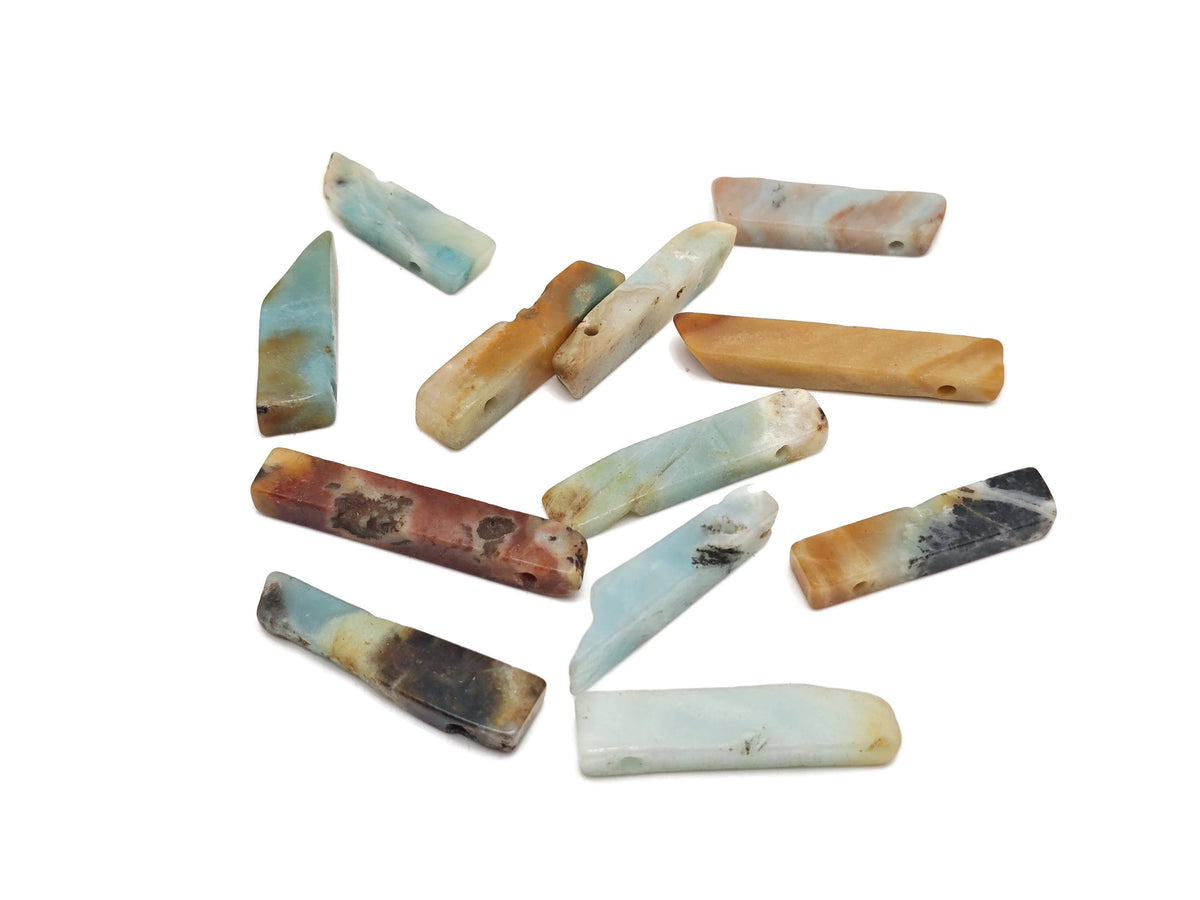 Caribbean calcite drilled tumbled gemstone pendant from GemstoneGO showcasing polished, vibrant orange and yellow hues with natural patterns.