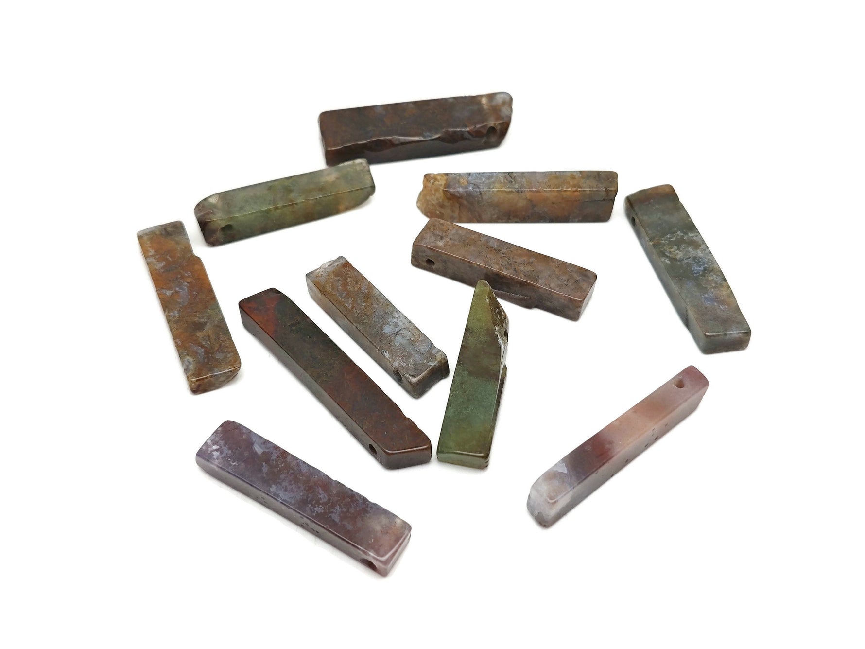 Moss agate drilled tumbled gemstone pendant with natural green and brown patterns, showcasing a polished, smooth surface.
