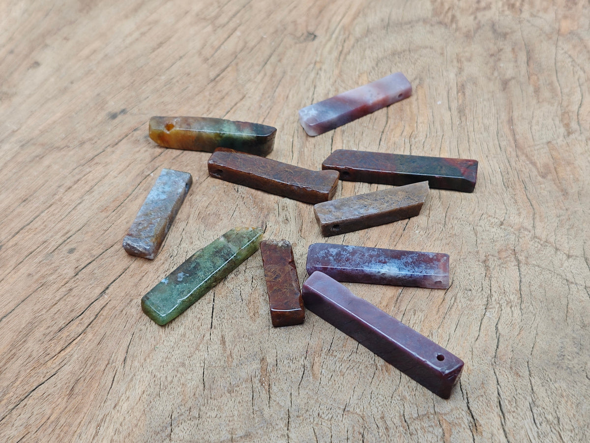 Moss agate drilled tumbled gemstone pendant showcasing green and brown natural patterns, crafted by GemstoneGO.