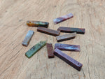Moss agate drilled tumbled gemstone pendant showcasing green and brown natural patterns, crafted by GemstoneGO.